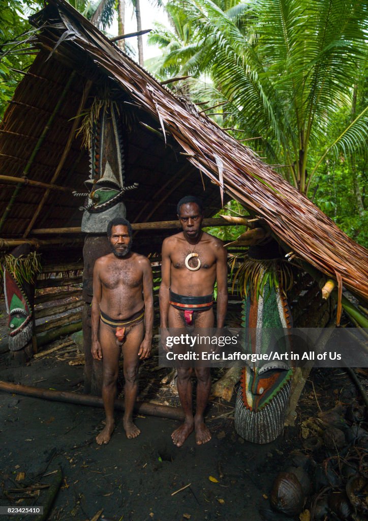 Portrait of chieftain Sekor and his father in front of a painted grade statue, Ambrym island, Olal, Vanuatu...