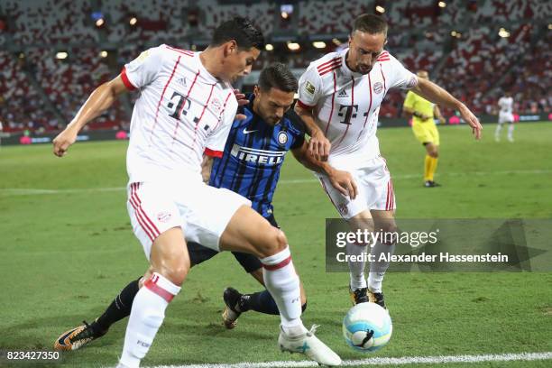 Franck Ribery of Bayern Muenchen and his team mate James Rodriguez battle for the ball with Danilo Dàmbrosio of Inter during the International...