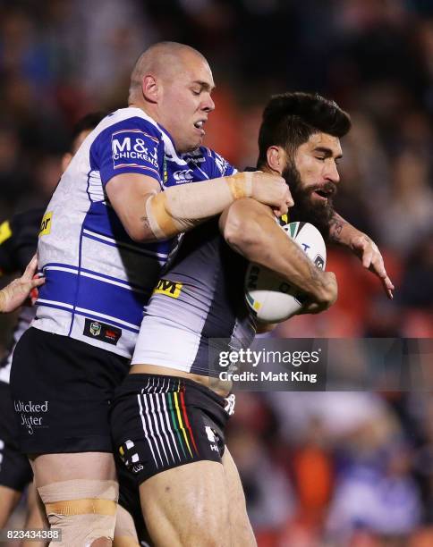 James Tamou of the Panthers is tackled by David Klemmer of the Bulldogs during the round 21 NRL match between the Penrith Panthers and the Canterbury...