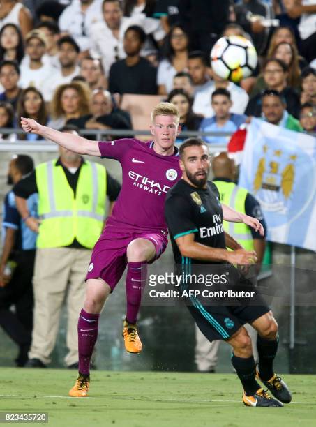 Manchester City midfielder Kevin de Bruyne, left, heads the ball against Real Madrid defender during the second half of the International Champions...