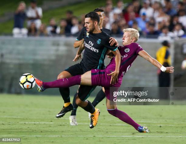 Real Madrid midfielder Dani Ceballos, left, and Manchester City midfielder Oleksandr Zinchenko vie the ball during the second half of the...