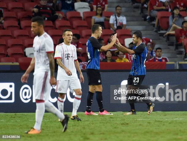 Inter Milan's Eder celebrates with teammate Ivan Perisic after his second goal against Bayern Munich during their International Champions Cup...