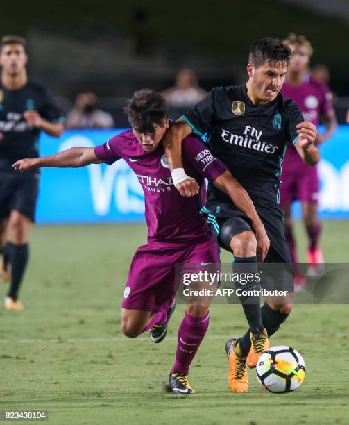 Manchester City midfielder Brahim Diaz, left, vies the ball against Real Madrid during the second half of the International Champions Cup match on...