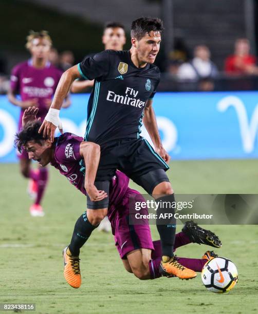 Manchester City midfielder Brahim Diaz, left, vies the ball against Real Madrid during the second half of the International Champions Cup match on...