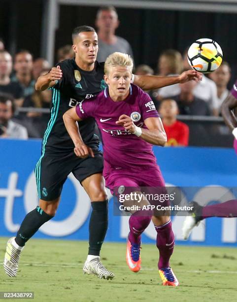 Manchester City midfielder Oleksandr Zinchenko , left, and Real Madrid forward Lucas Vazquez vie for the ball during the second half of the...