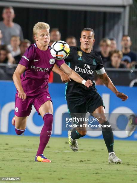 Manchester City midfielder Oleksandr Zinchenko , left, and Real Madrid forward Lucas Vazquez vie for the ball during the second half of the...