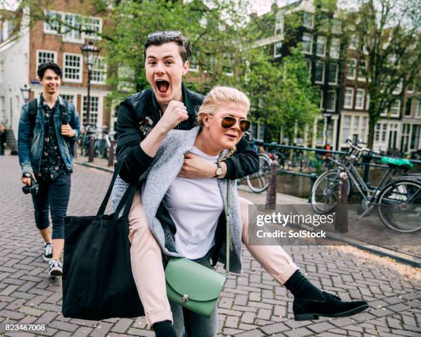 piggyback in amsterdam - piggyback stock pictures, royalty-free photos & images