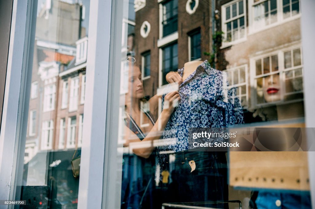 Young Woman Working in a Shop Window