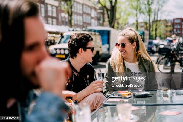 refreshments with friends in amsterdam - sidewalk cafe stock pictures, royalty-free photos & images