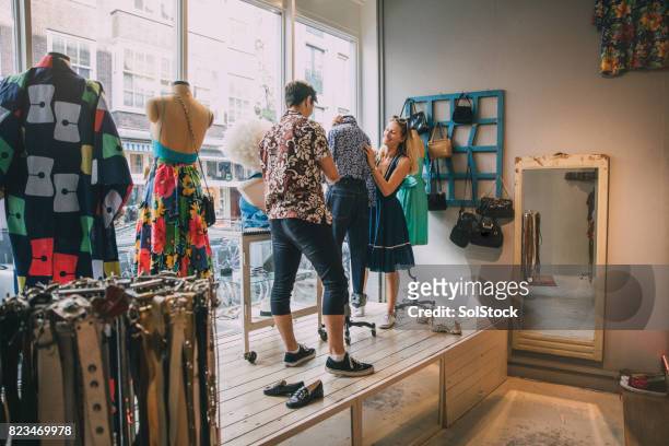 dressing a mannequin in a shop window - vintage fashion stock pictures, royalty-free photos & images
