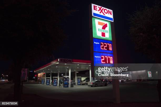 Signage stands illuminated at night at an Exxon Mobil Corp. Gas station in Dallas, Texas, U.S., on Monday, July. 24, 2017. Exxon Mobil Corp. Is...