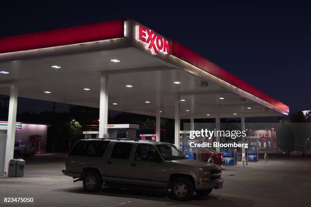 Vehicle exits an Exxon Mobil Corp. Gas station at night in Dallas, Texas, U.S., on Monday, July. 24, 2017. Exxon Mobil Corp. Is scheduled to release...