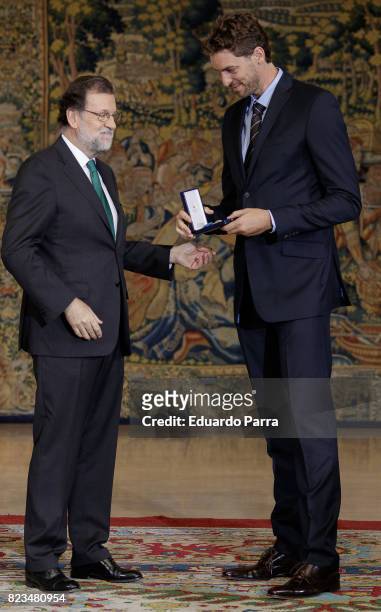 President Mariano Rajoy and basketball player Pau Gasol attend the 'Medals to Merit in Work' delivery at Moncloa palace July 27, 2017 in Madrid,...