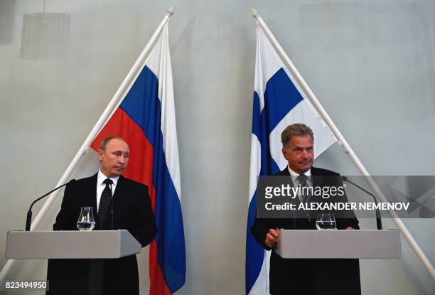 Finland's President Sauli Niinisto and Russian President Vladimir Putin attend a press conference with Finnish President in Punkaharju hotel in...
