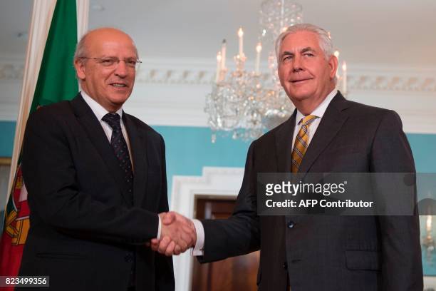 Secretary of State Rex Tillerson shakes hands with Portuguese Foreign Minister Augusto Santos Silva at the State Department in Washington, DC, on...