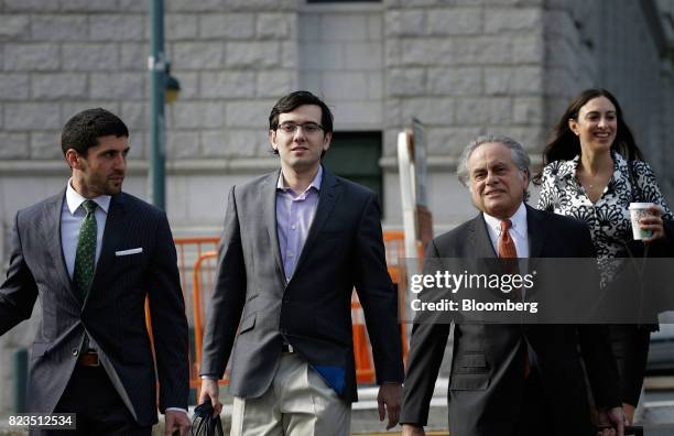 Martin Shkreli, former chief executive officer of Turing Pharmaceuticals AG, center left, arrives at federal court with his attorney Benjamin...