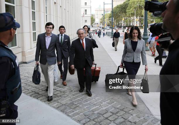 Martin Shkreli, former chief executive officer of Turing Pharmaceuticals AG, left, arrives at federal court with his attorney Benjamin Brafman,...