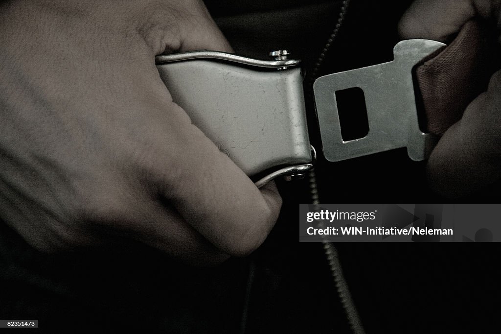 Close-up of a person strapping seat belt in an airplane, Spain 