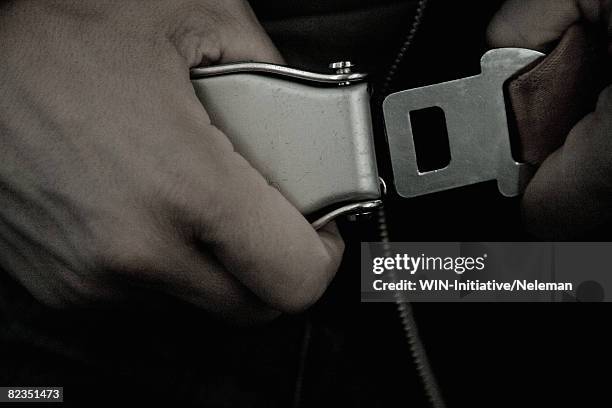 close-up of a person strapping seat belt in an airplane, spain  - safety harness stockfoto's en -beelden