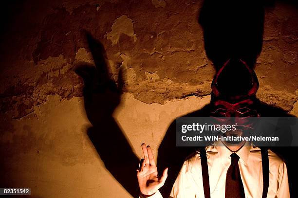 young man making shadow puppet on a wall, uruguay  - depictions stockfoto's en -beelden