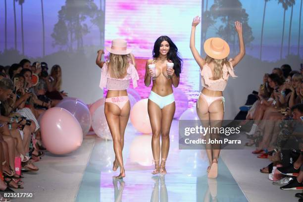 Models walk the runway at the LOLLI SWIM fashion show during FUNKSHION Swim Fashion Week at Funkshion Tent on July 21, 2017 in Miami Beach, Florida.