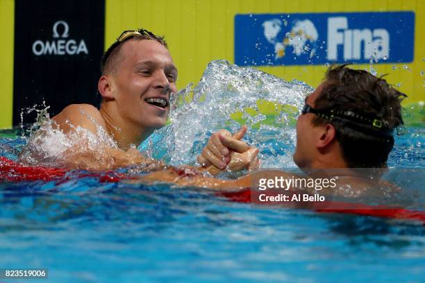 Gold medalist Caeleb Remel Dressel of the United States and silver medalist Nathan Adrian of the United States celebrate following the Men's 100m...