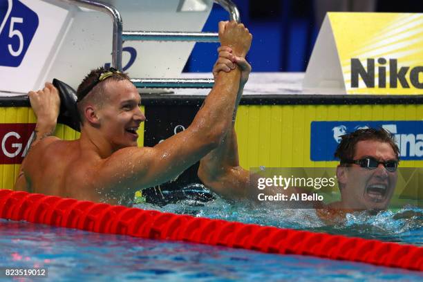 Gold medalist Caeleb Remel Dressel of the United States and silver medalist Nathan Adrian of the United States celebrate following the Men's 100m...