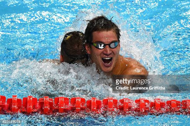 Gold medalist Caeleb Remel Dressel of the United States and silver medalist Nathan Adrian of the United States celebrate following the Men's 100m...