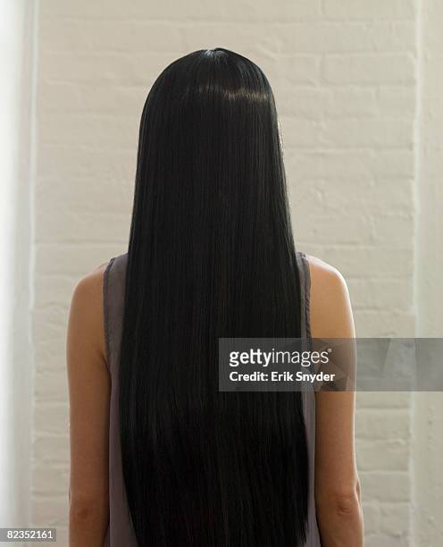 woman with long, dark, straight hair - straight hair foto e immagini stock