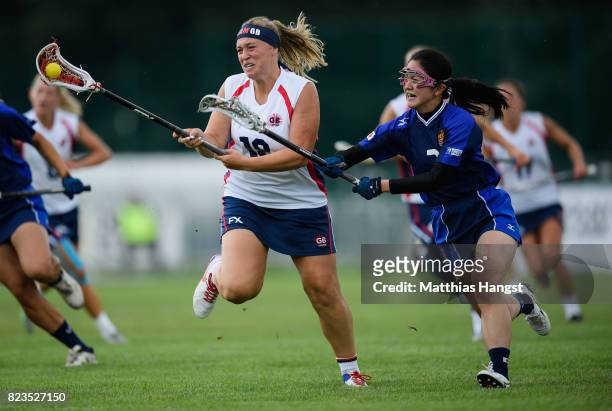 Sophie Morrill of Great Britain is challenged by Nozomi Tanaka of Japan during the Lacrosse Women's match between Great Britain and Japan of The...