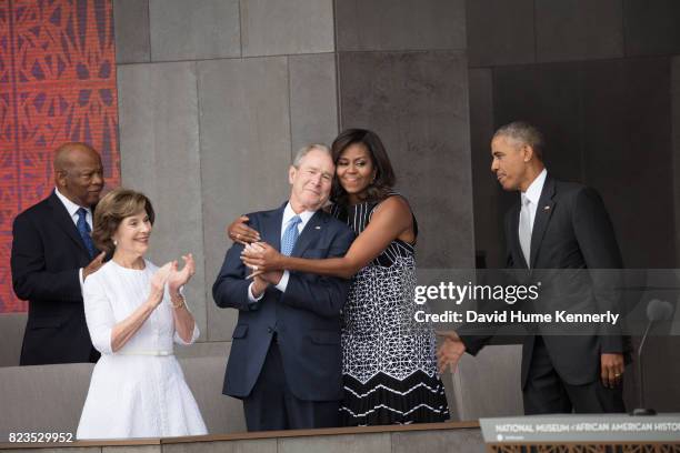 first-lady-michelle-obama-hugs-former-president-george-w-bush-at-the-opening-of-the-national.jpg