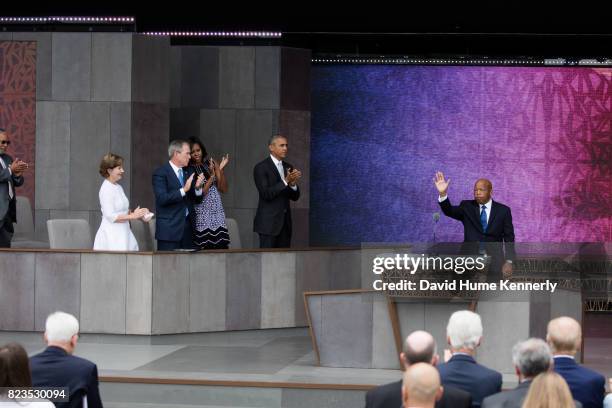 Congressman John Lewis waves as he receives a standing ovation at the opening of the National Museum of African American History and Culture,...