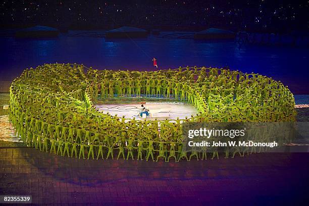 Summer Olympics: View of Chinese pianist Lang Lang and 5-year-old Li Muzi perform in center of human created representation of Bird's Nest stadium at...