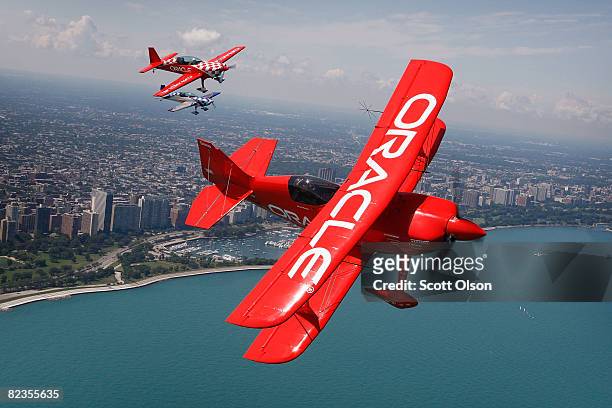 Pilot Sean Tucker and his son Eric fly their aircraft over Lake Michigan as they prepare for this weekend's Chicago Air and Water Show August 14,...