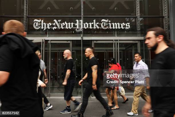 People walk past the New York Times building on July 27, 2017 in New York City. The New York Times Company shares have surged to a nine-year high...