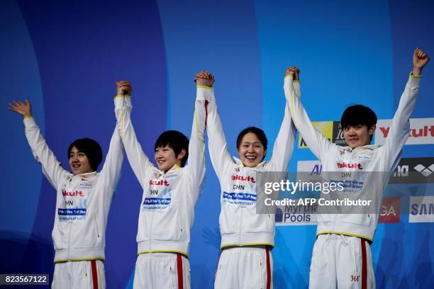 Silver medalists China's Ai Yanhan, China's Liu Zixuan, China's Zhang Yuhan and China's Li Bingjie celebrate on the podium of the women's 4x200m...
