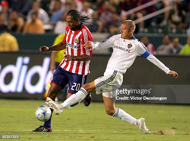 David Beckham of the Los Angeles Galaxy challenges Roberto Nurse of CD Chivas USA in the first half during their MLS match at the Home Depot Center...
