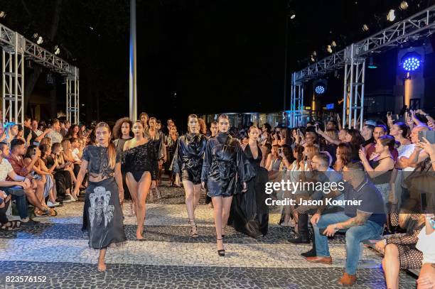 Model poses on the runway with Thesis Shoes at the "Tankovitz on Lincoln Road" event presented by DIVE Swim Week on July 21, 2017 in Miami, Florida.