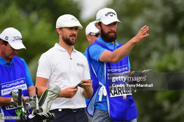 Rikard Karlberg of Sweden and his caddy line up his first shot on the 13th tee during the Porsche European Open - Day One at Green Eagle Golf Course...