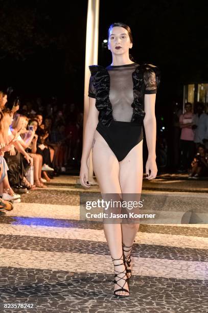 Model poses on the runway with Thesis Shoes at the "Tankovitz on Lincoln Road" event presented by DIVE Swim Week on July 21, 2017 in Miami, Florida.