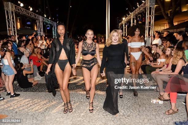 Model poses on the runway with Thesis Shoes at the "Tankovitz on Lincoln Road" event presented by DIVE Swim Week on July 21, 2017 in Miami, Florida.