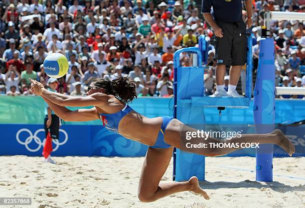 Norway's Nila Ann Hakedal dives to return the ball to China's team in their women's round of 16 beach volleyball match at Beijing's Chaoyang Park...