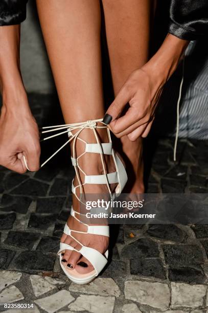 Model poses on the runway with Thesis Shoes at the "Tankovitz on Lincoln Road" event presented by DIVE Swim Week on July 21, 2017 in Miami, Florida.