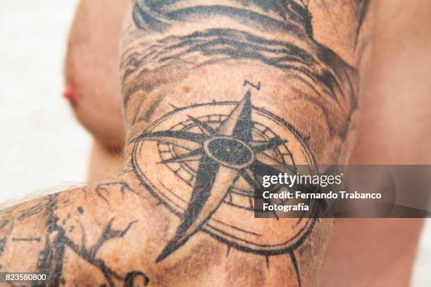 arm tattooed with compass rose - wind rose compass stock pictures, royalty-free photos & images