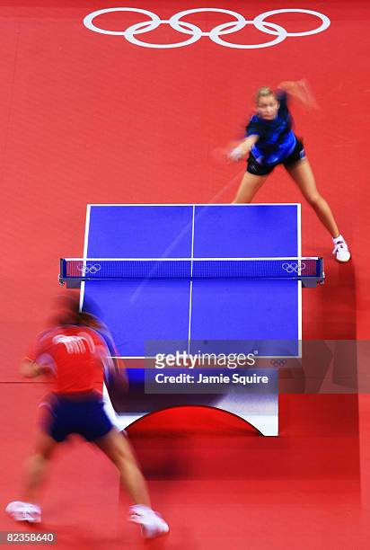 Daniela Dodean of Romania plays a shot against Jun Gao of USA during their Women's Team Bronze Play-off Round 1 match at the Peking University...