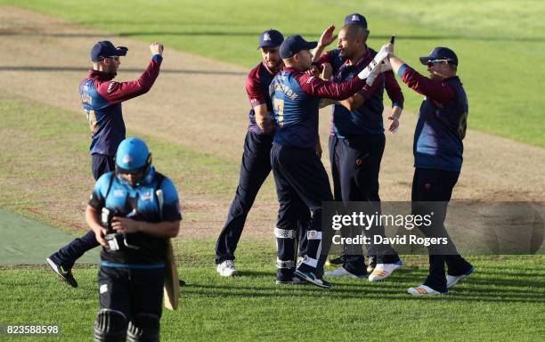 Rory Kleinveldt of Northamptonshire celebrates with team mates after taking the wicket of Joe Leach during the NatWest T20 Blast match between...