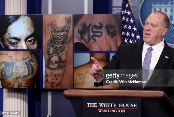 Tom Homan, Director of Immigration and Customs Enforcement, answers questions in front of gang related photos from the MS-13 gang during a daily...
