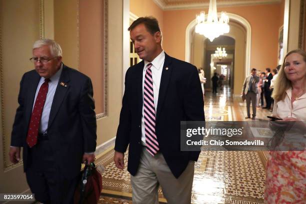 Sen. Mike Enzi and Sen. Dean Heller leave a Republican caucus meeting and head to the Senate Fllor in the U.S. Capitol July 27, 2017 in Washington,...