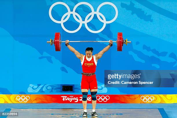Cao Lei of China completes a new Olympic record lift of 128k in the women's 75kg weightlifting event at the Beijing University of Aeronautics &...