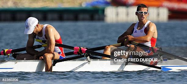 France's Maxime Goisset and Frederic Dufour react after finishing the lightweight men's double sculls semifinal A/B 2 at the Shunyi Rowing and...